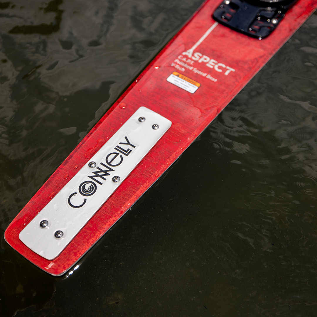 Red Connelly Aspect water ski floating on water, featuring a white Connelly logo plate and text.