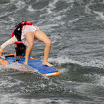 Wakeboarder bending back effortlessly, touching board on waves—Wild Thing style.