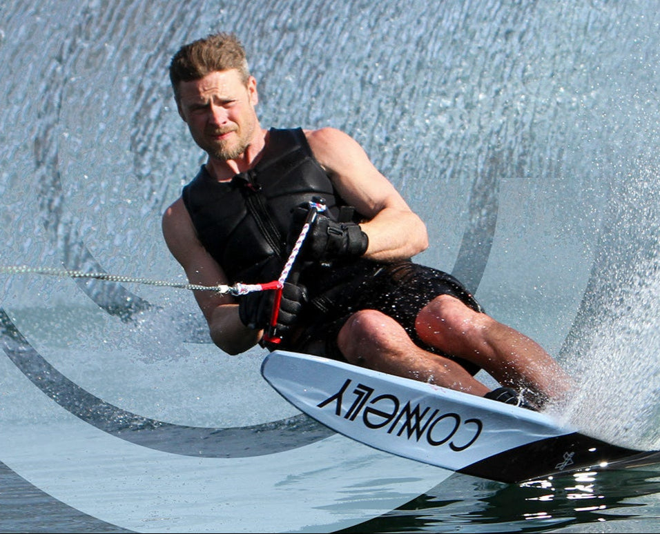 Water skier making a turn throwing up water making a turn with an overlayed Connelly logo.