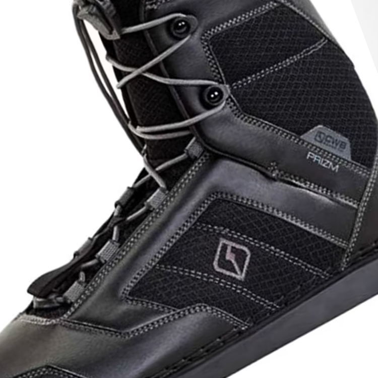 Black snowboard boot with gray laces and textured panels.