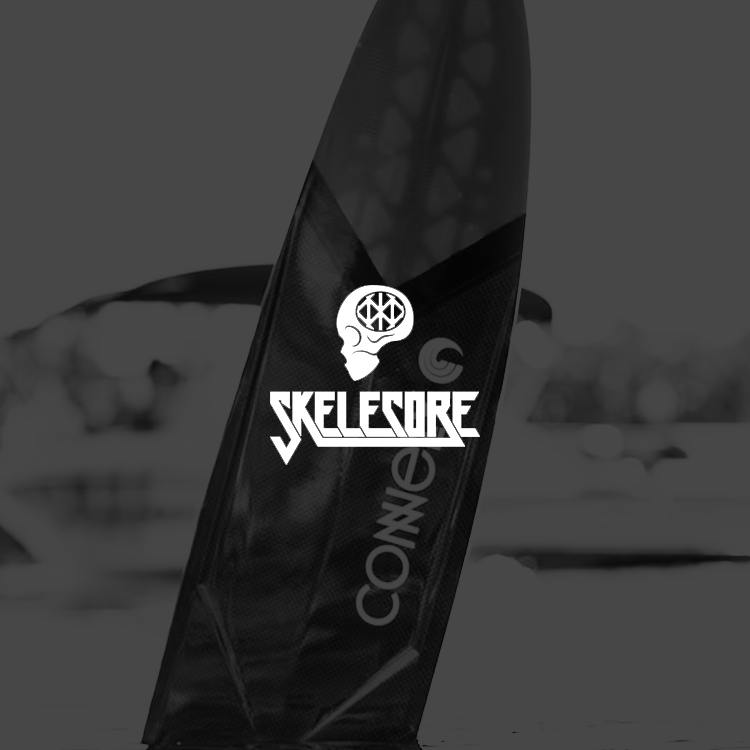 Skateboard with SKELESCORE logo featuring a skull design on a blurred background.