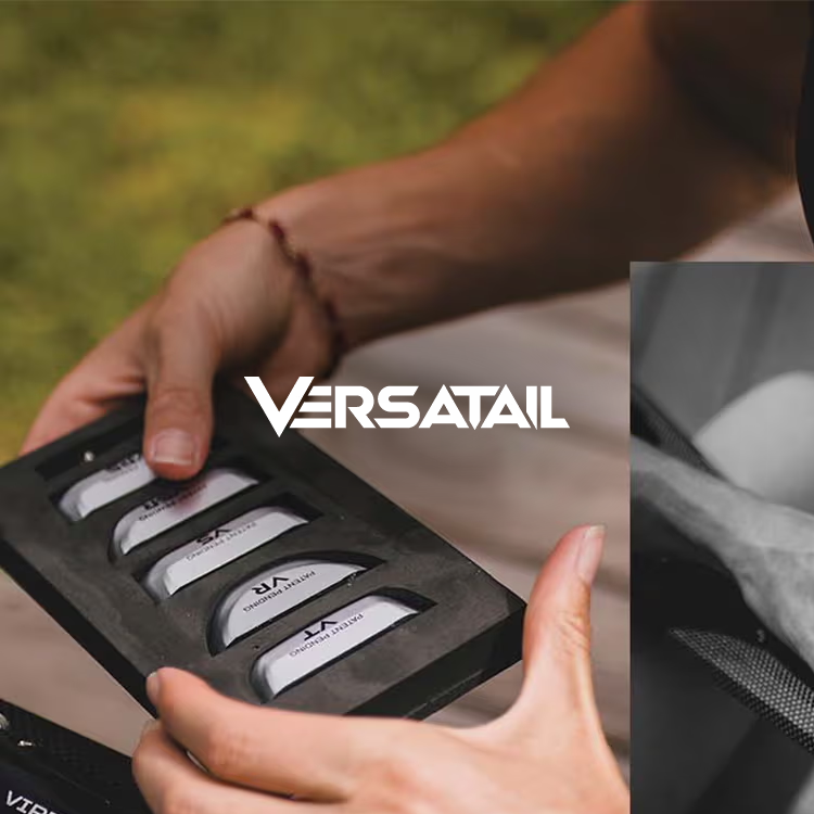 Hands holding a set of Versatail sailing tools.