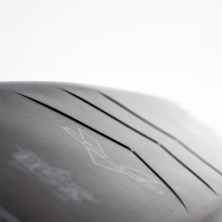 Close-up of a tire tread with subtle grooves against a white background.