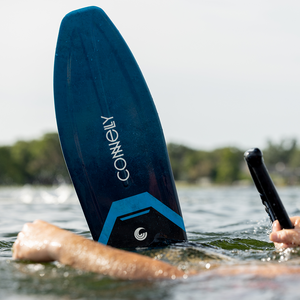 Close-up of the Connelly Big Daddy ski floating on the water, highlighting the sleek blue and black design.
