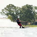 A skier in a life vest riding the Connelly Big Easy ski, cutting through the water with ease.