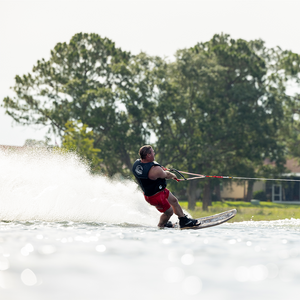 A skier in a life vest riding the Connelly Big Easy ski, cutting through the water with ease.