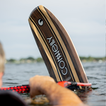 Close-up of the Connelly Big Easy ski partially submerged in water, displaying its elegant woodgrain finish.