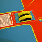 Detail of Fun 3 handle grips and blue seating pads on red surface.