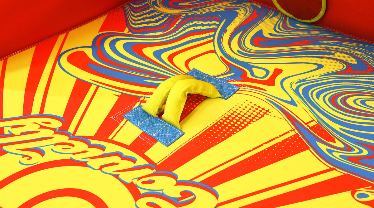 Close-up of Super Fun 3 padded handle on colorful swirl design surface.