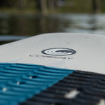 Close-up of the Connelly Bentley wakesurf board's textured traction pad with the Connelly logo on the deck.