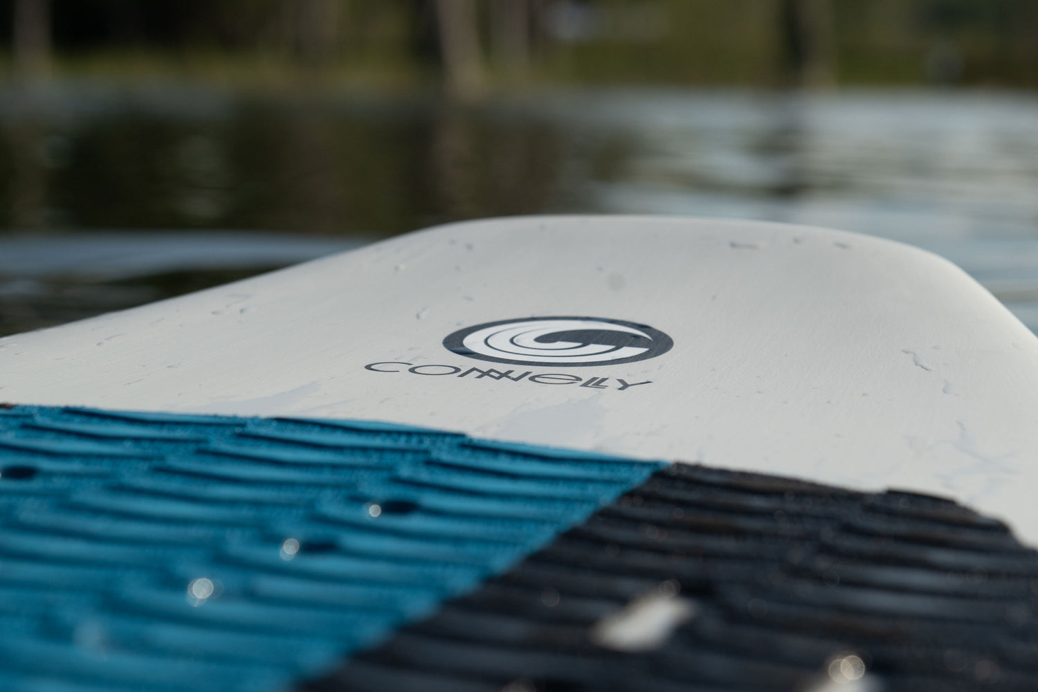 Close-up of the Connelly Bentley wakesurf board's textured traction pad with the Connelly logo on the deck.