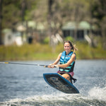 Rider in mid-air while kneeboarding on the Boost, gripping the handle and maintaining balance over the water’s wake.