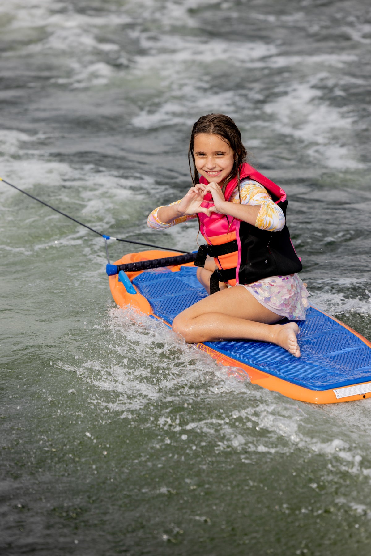 Wild Thing: Pink life jacket, heart hands, kneeboard ride.