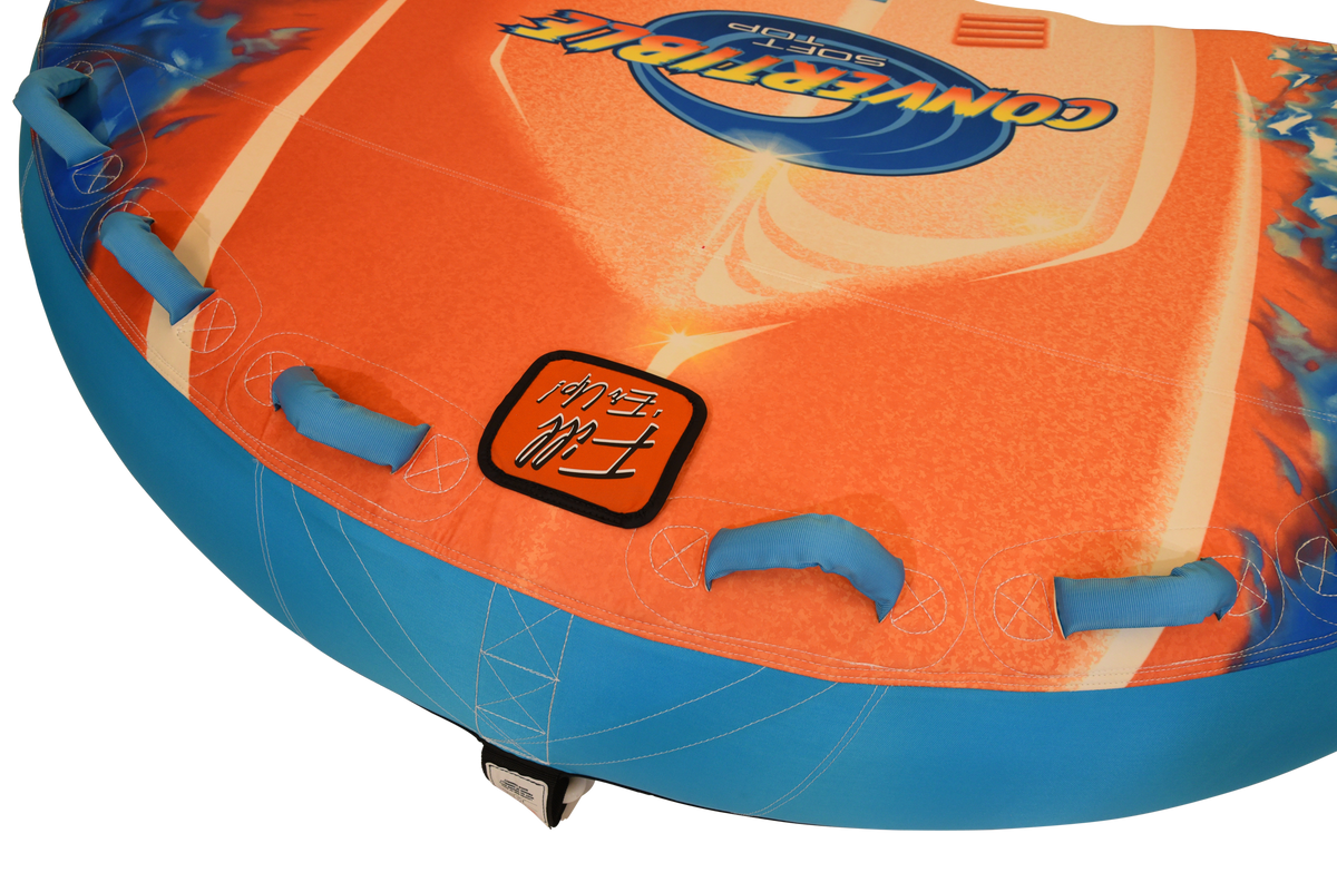Close-up of blue grab handles and Fill ‘Er Up valve patch on orange and blue deck surface.