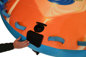 Close-up of hand opening valve cover on Convertible Soft Top with blue grab handles nearby.