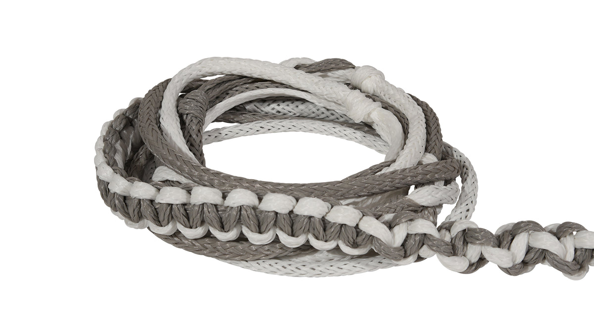 Close-up of coiled grey and white Poly-E Rope showing braided texture and looped strands.