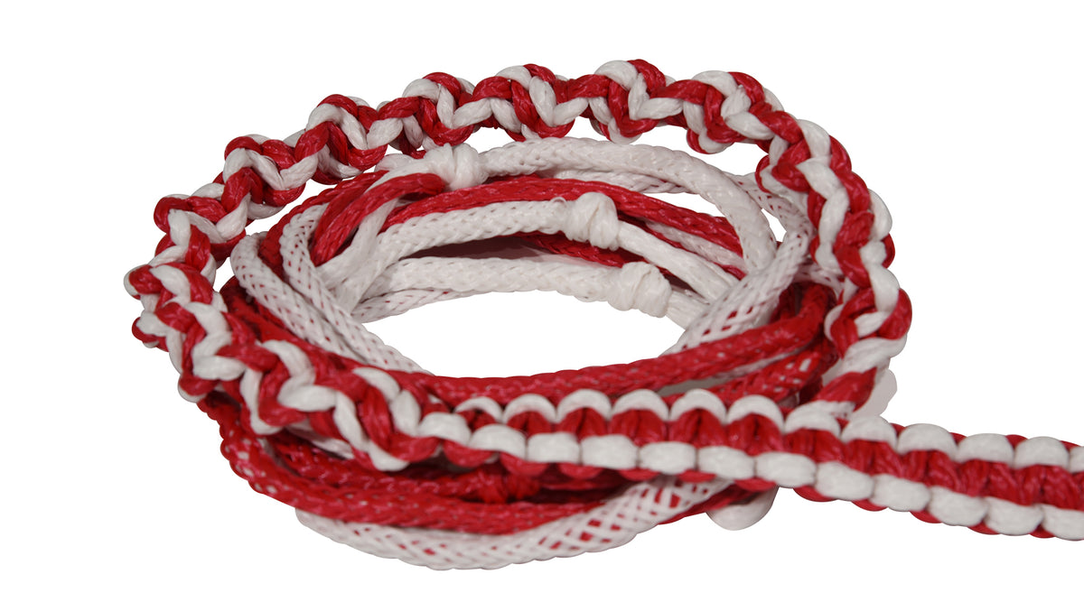 Close-up of coiled red and white Poly-E Rope showing braided pattern and smooth texture.