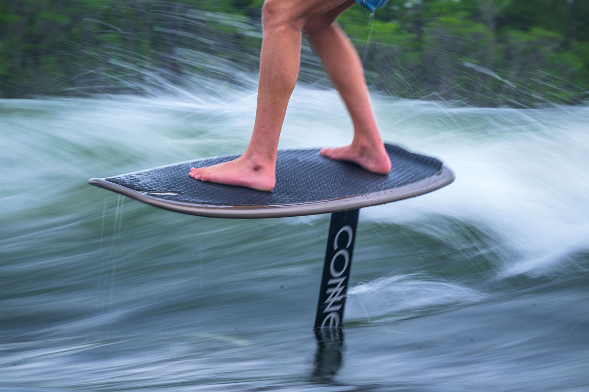 Person riding a Connelly wakefoil in the water.