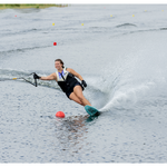 A skier carving through the water on the Women's Aspect ski, wearing a Connelly life vest while holding a handle.