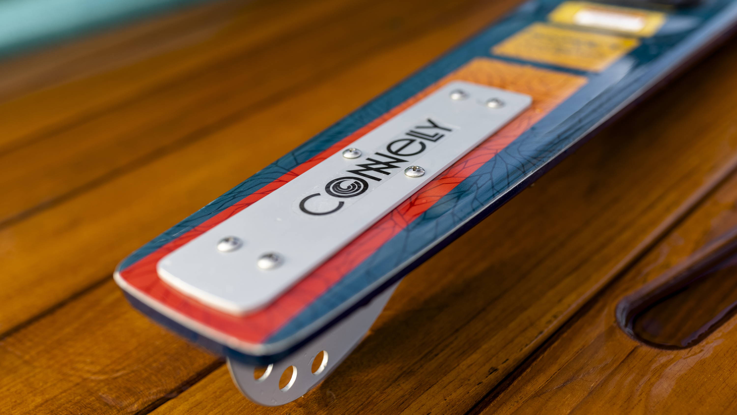 Close-up of a Connelly ski corner on a wooden surface.