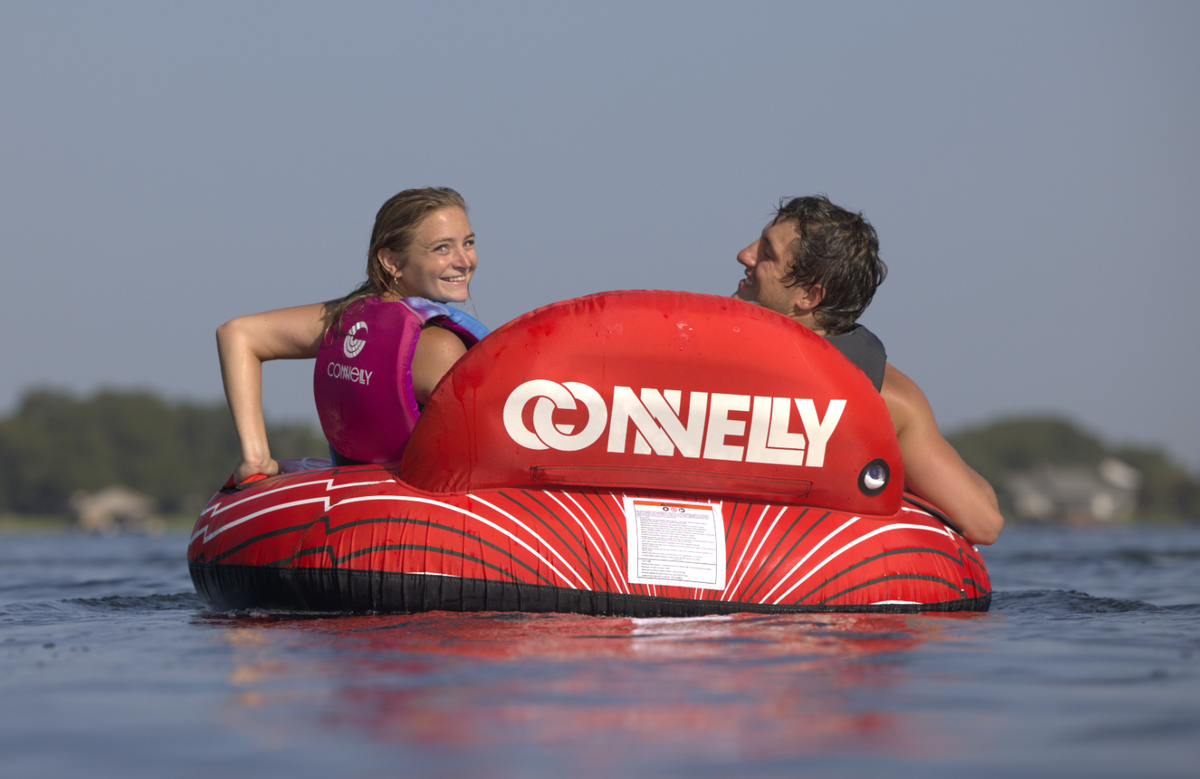 Back of the Racer 2 tube showing the red inflatable backrest with the logo, black bottom edge, and tow rope attachment.