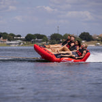 Side view of Big Easy 4, with four riders enjoying the ride while being pulled across the water.