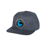 Dark gray Patched Hat with a structured six-panel design and a circular blue and black embroidered logo patch.