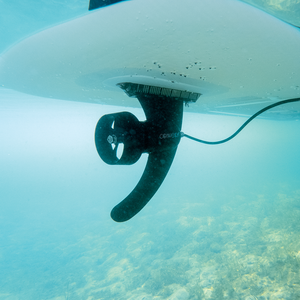 Underwater view of the Power Fin attached to a paddleboard, showing the motorized propeller in action.